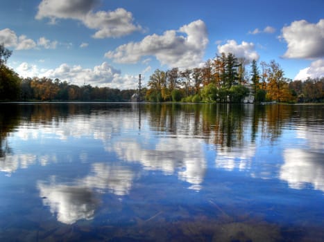 Autumn landscape with trees and reflection in lake