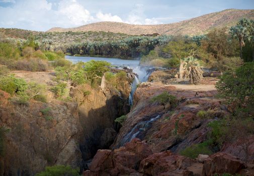 The Epupa Falls lie on the Kunene River, on the border of Angola and Namibia