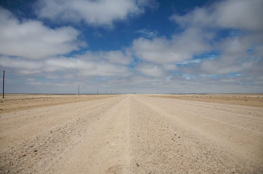 Large sand and flat road in the desert in the area of Swakopund in Namibia