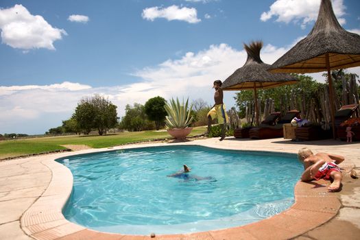 Kids playing around a swimming pool in Namibia, Harnas Foundation