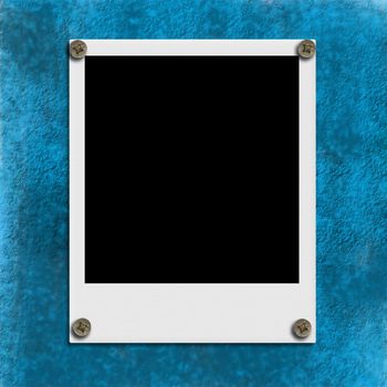Instant empty picture frame hung on the blue wall 