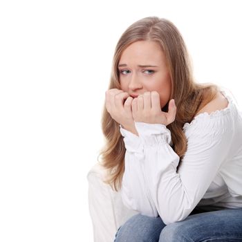 Stressed young woman eating her nails , isolated on white