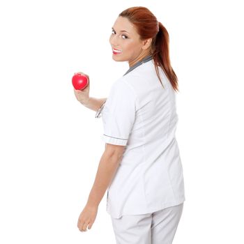 Female doctor with stethoscope holding heart. Isolated on white