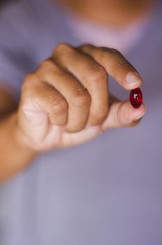 a red tablet is handed out by a woman.