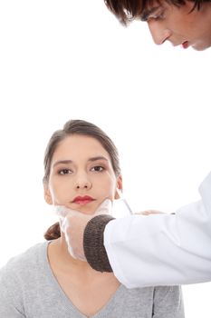 Plastic surgeons giving botox injection in female skin. Isolated on white