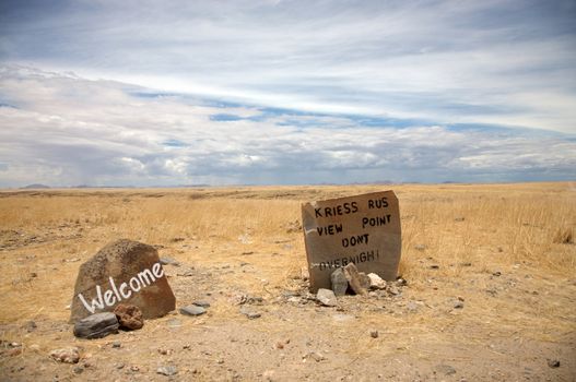 Welcome message in Kriess Rus written on a rock at the entrance of a national park in Namibia