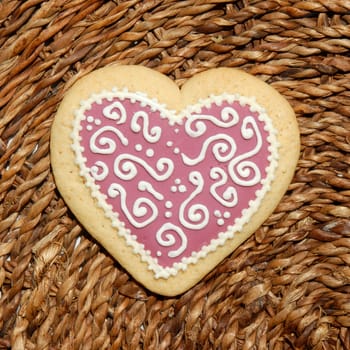 heart shaped cookie on a background of raffia 