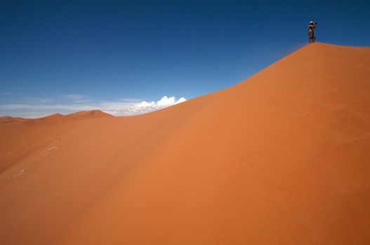 Man Taking photos on the biggest dune in Sossusvlei