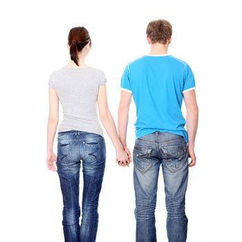 Young couple from behind, holding hands