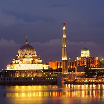 Golden mosque near river in night in Putrajaya, Malaysia, Asia.