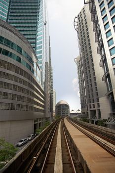 City scenery with railroad over business skyscraper.