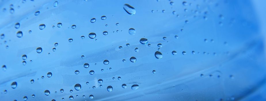 Closeup of small water drops on a blue background