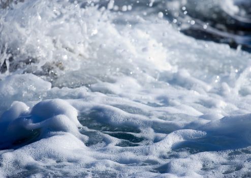 Wild water splash - wave crashing on the shore close up  