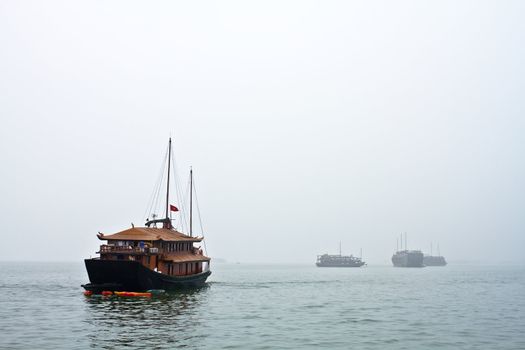Boats head off to work in a windy cloudy day in Vietnam