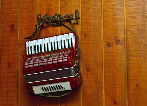 Decorative accordion on an old wooden wall