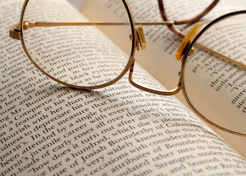 a close up of glasses on a book