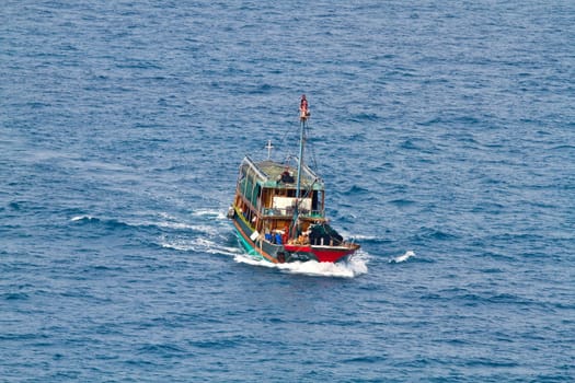 A ferry boat is carrying people to the places of interest on the sea