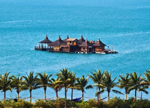 Holiday cottages on the sea with tropical landscape nearby