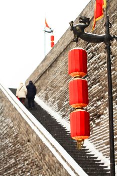 Aged couple climbing the ladders of the rampart in the first snow in 2011