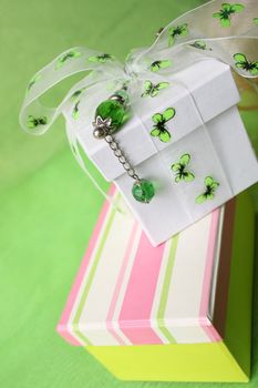 Pink gift box and white box with ribbon and pin
