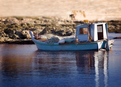 Small old wooden fishing boat near the coast