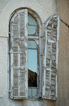 Old window with wooden  shabby paint shutters  in Bauhaus style building