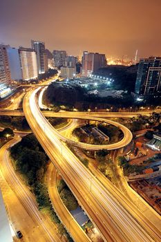 Freeway in night with cars light in modern city. 