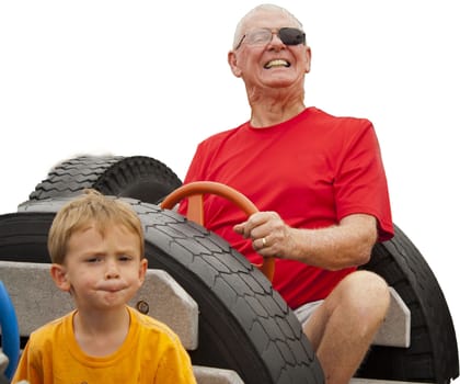 Grandfather and grandson in playground car