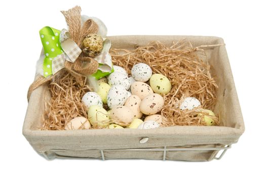 Colorful chocolate easter eggs in brown basket