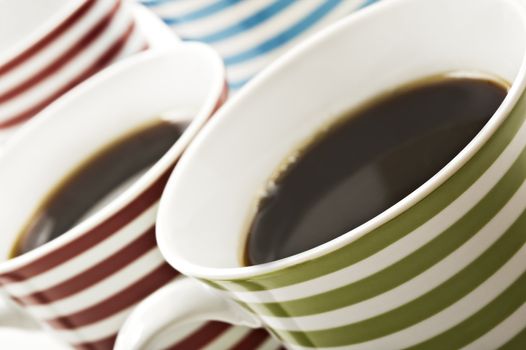 Close ups of mugs of black coffee