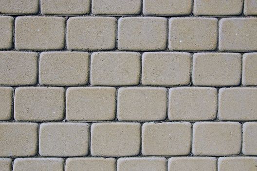 Path background fragment. Path made of small grey bricks.