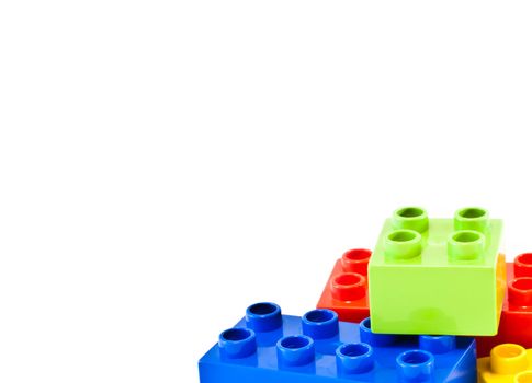 Plastic building blocks on white background. Bright colors.