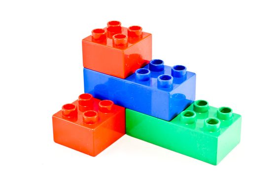 Plastic building blocks on white background. Bright colors.