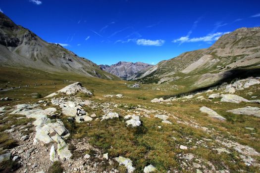 View on the mountains, the rocks and grass by beautiful weather at the Cayolle pass, France