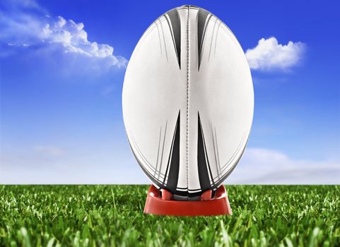 Rugby ball on the field with sky and clouds