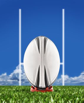 Rugby ball on field with goal posts