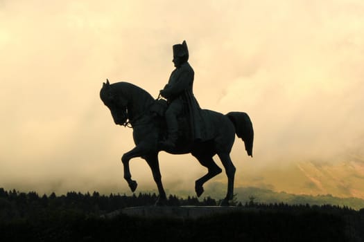 Sculpture of Napoleon on his horse by cloudy sunset, Laffry, France. It was realized by Fremiet artist.