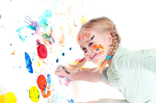 Studio shot of little girl playing with colors