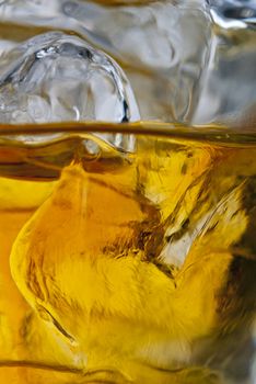 Close up photo of a glass of whiskey on the rocks