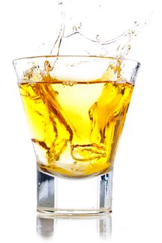 Splash of whiskey on the rocks isolated on white