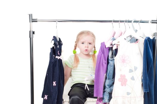 Shot of cute toddler girl choosing clothes