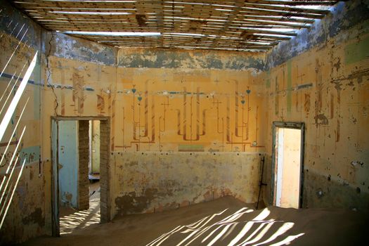 A small sand dune formed in an old derelict house in Kolmanskop, Namibia