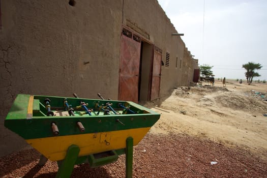 Wide angle of a green Foosball photographed in the street of Mopti in Mali