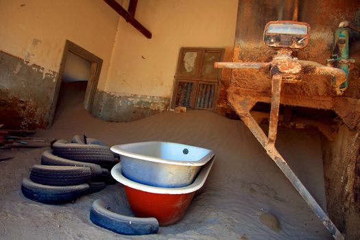 A small sand dune formed in an old derelict house in Kolmanskop, Namibia