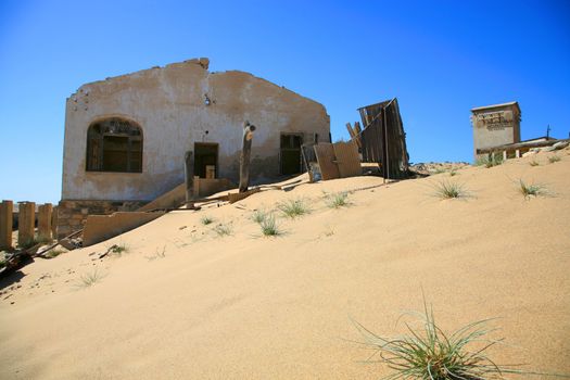 Abandoned old house on a hill with intense blue sky - Luderitz in Namibia