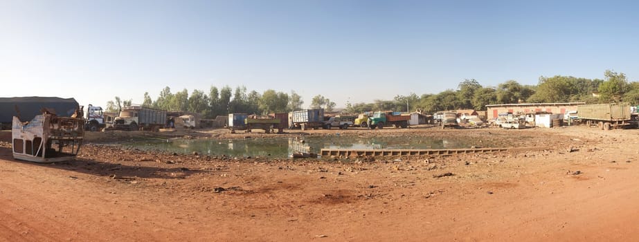 Panoramic view of a field with abandoned cars and trucks in Mopti, Mali
