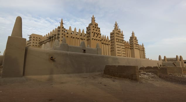 The big mosque in Djenné  and the traditional mud building in Mali. 
