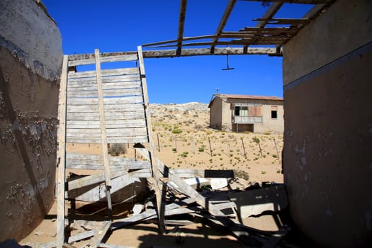 House covered by sand in the Ghost city of Kolmanskop - Luderitz in Namibia