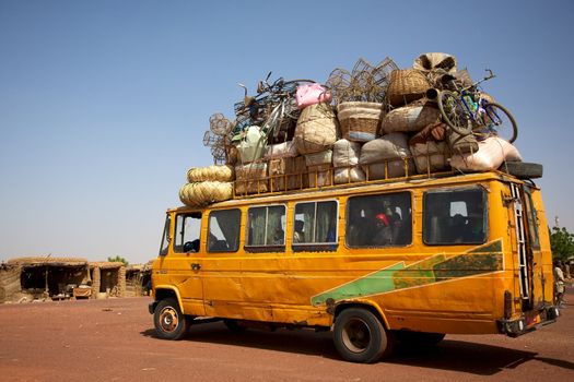 Over loaded mini van on a road in Mali