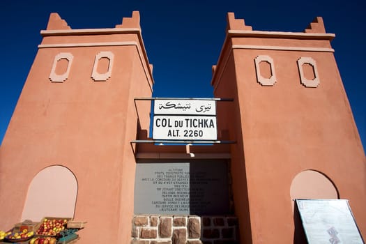 Moroccan architecture and sign board at the col du tichka pass in the atlas mountains in morrcco with blue sky